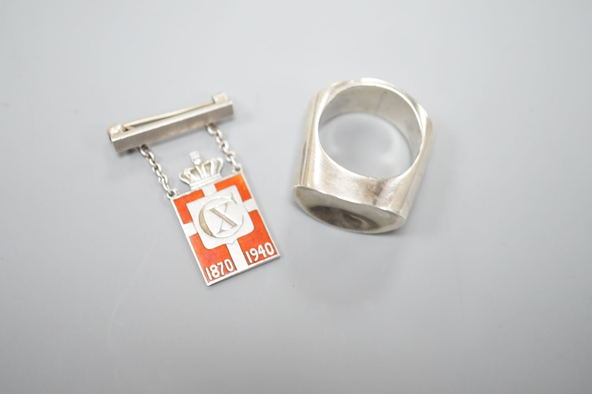 A Georg Jensen sterling ring, no. A11O B, size Q and a Georg Jensen 925 and enamel CX 1870-1940 King Christian drop brooch, 32mm.
